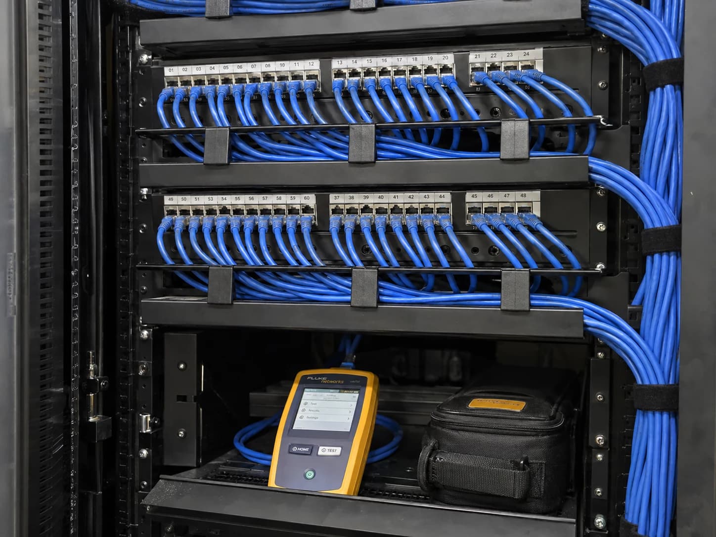 Organized Ethernet patch panels, cable managers and a cable certification tester